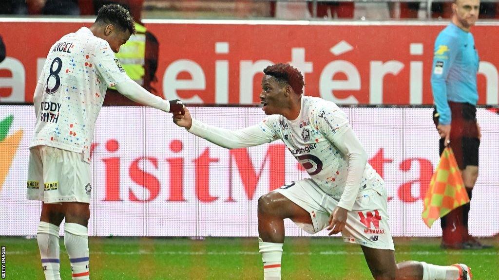 Angel Gomes celebrates with Lille forward Jonathan David