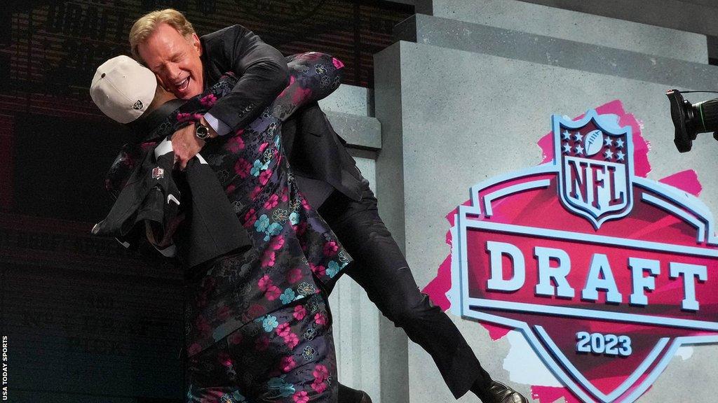 Tyree Wilson lifts NFL commissioner Roger Goodell on stage after being selected during the 2023 NFL Draft