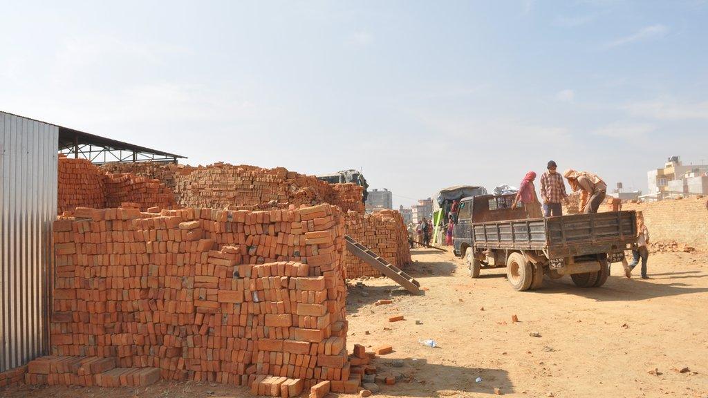 Piled up bricks near an improved kiln