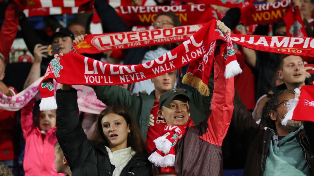 Liverpool fans hold up scarves