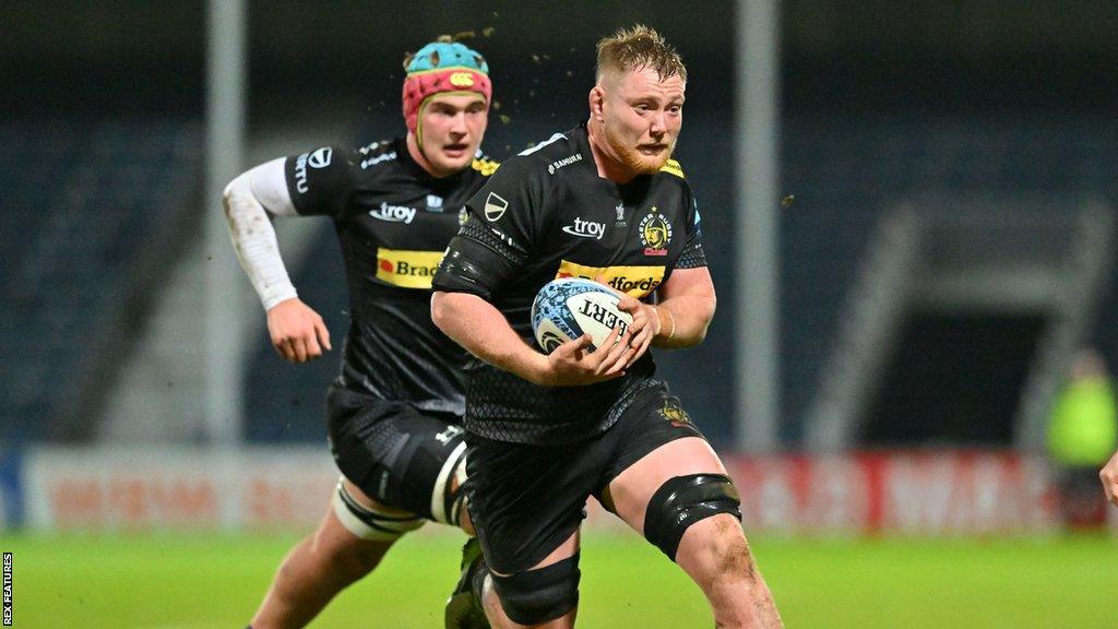 Hallam Chapman (right) runs with the ball during a friendly game for Exeter