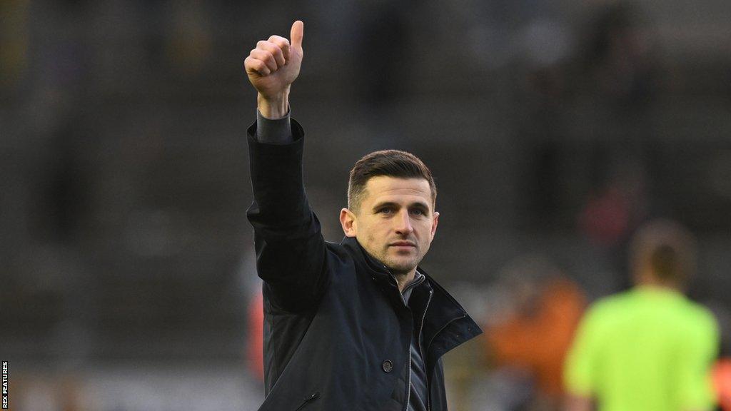 Portsmouth head coach John Mousinho gives the thumbs up to the Pompey fans