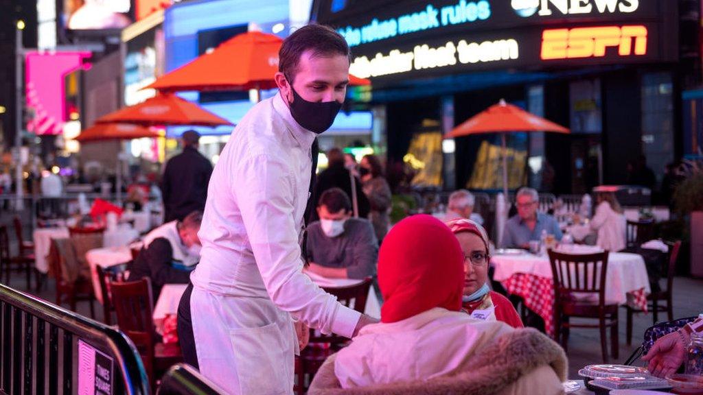 Waiter serving diners at Times Square