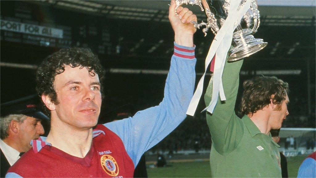 Charlie Aitken lifts the League Cup with keeper Jim Cumbes after beating Norwich City at Wembley in 1975