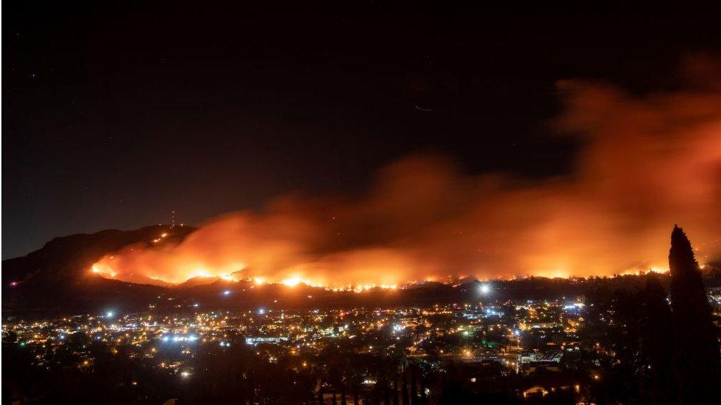 A long exposure photo shows the Maria fire as it races across a hillside in Santa Paula