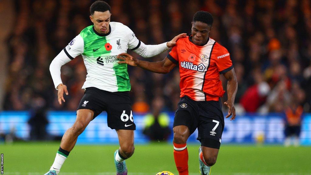 Trent Alexander Arnold challenges Chiedozie Ogbene for the ball