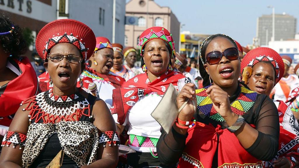 Hundreds of people adorned with traditional regalia march through the streets of Durban to celebrate Africa Day