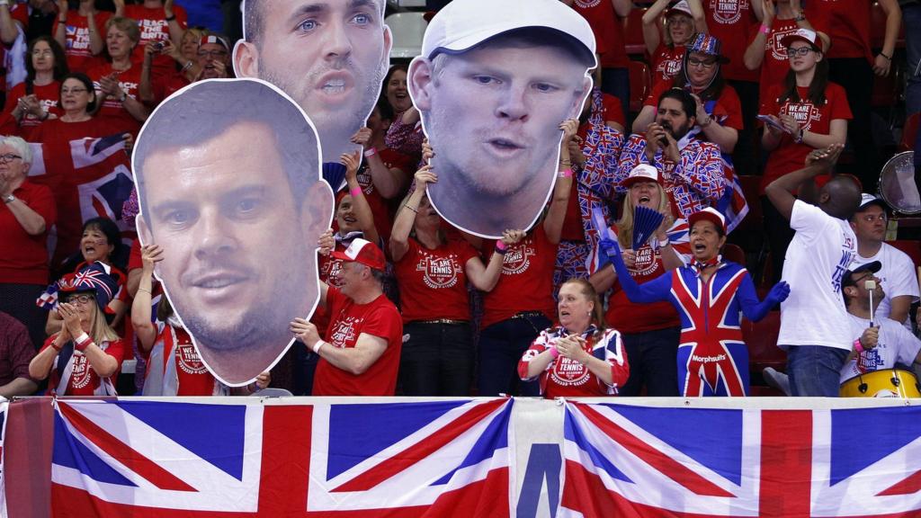 GB fans hold up cut outs of Dan Evans, Kyle Edmund and Leon SMith