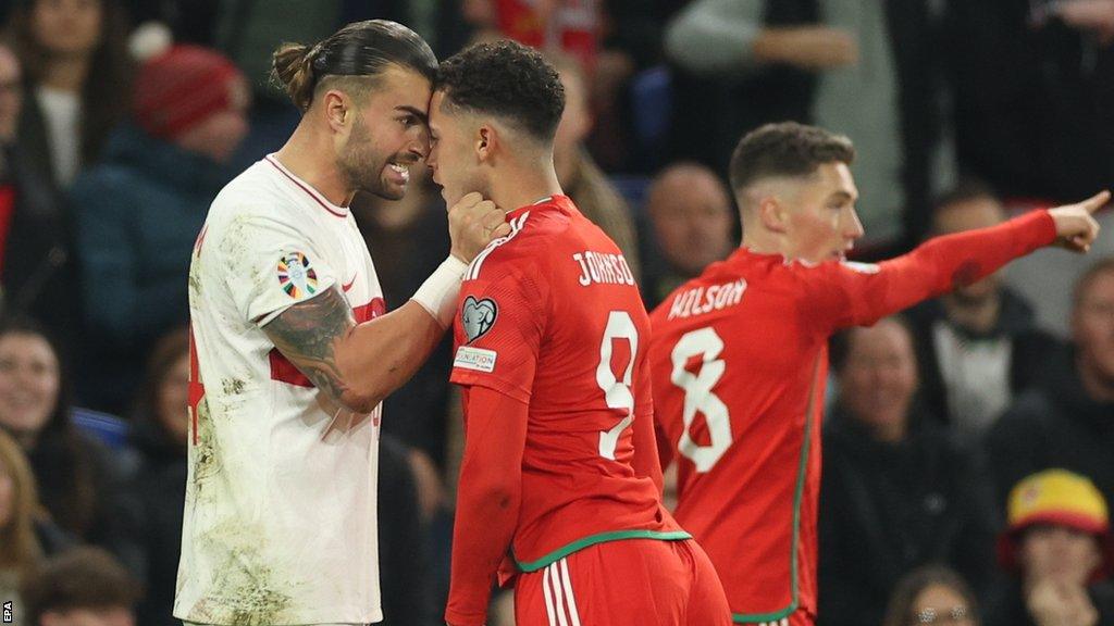 Turkey's Abdulkerim Bardakci (L) and Brennan Johnson of Wales come face to face in a sometimes fiery qualifier