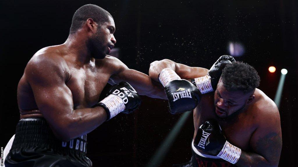 Daniel Dubois throws a punch at Jarrell Miller