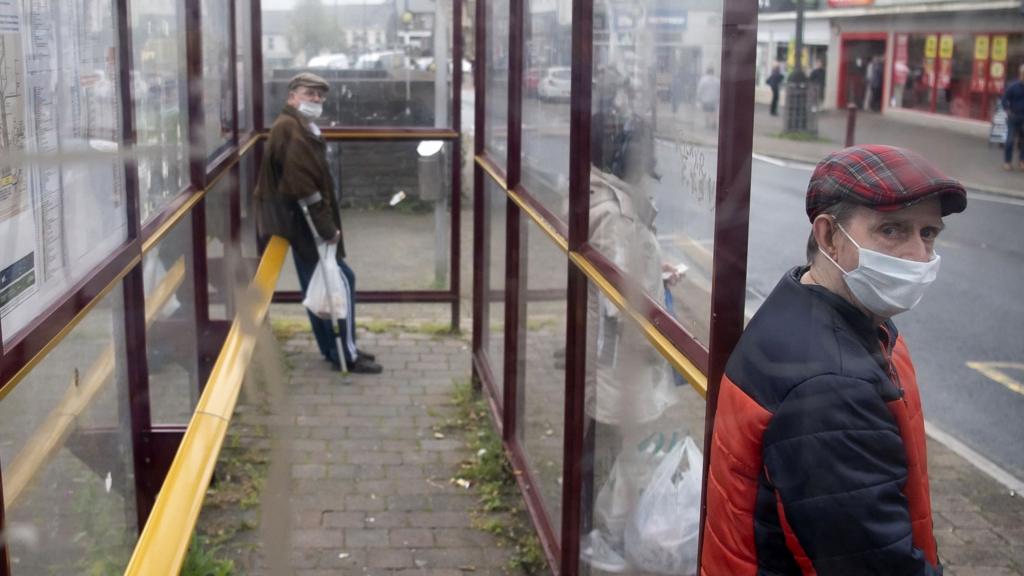 Men at bus stop in Caerphilly