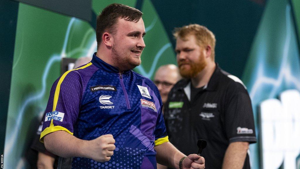 Luke Littler celebrates winning his match against Matt Campbell on day ten of the Paddy Power World Darts Championship at Alexandra Palace