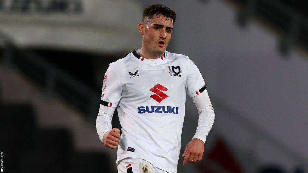 Dawson Devoy running with the ball during a match for MK Dons