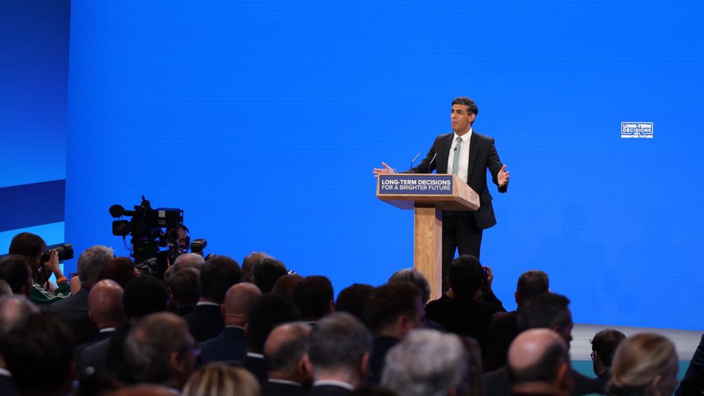 Rishi Sunak speaking on stage at Conservative conference 4 October