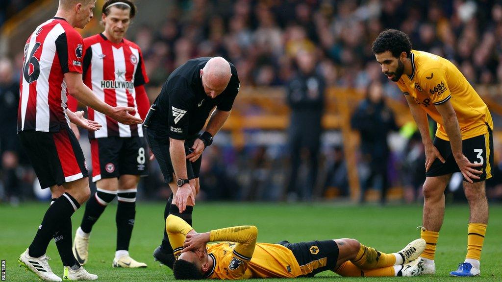 Wolverhampton Wanderers' Matheus Cunha reacts after sustaining an injury