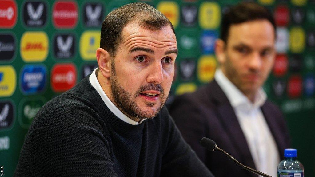 John O'Shea talks at Monday's news conference in Dublin as FAI director of football Marc Canham listens on