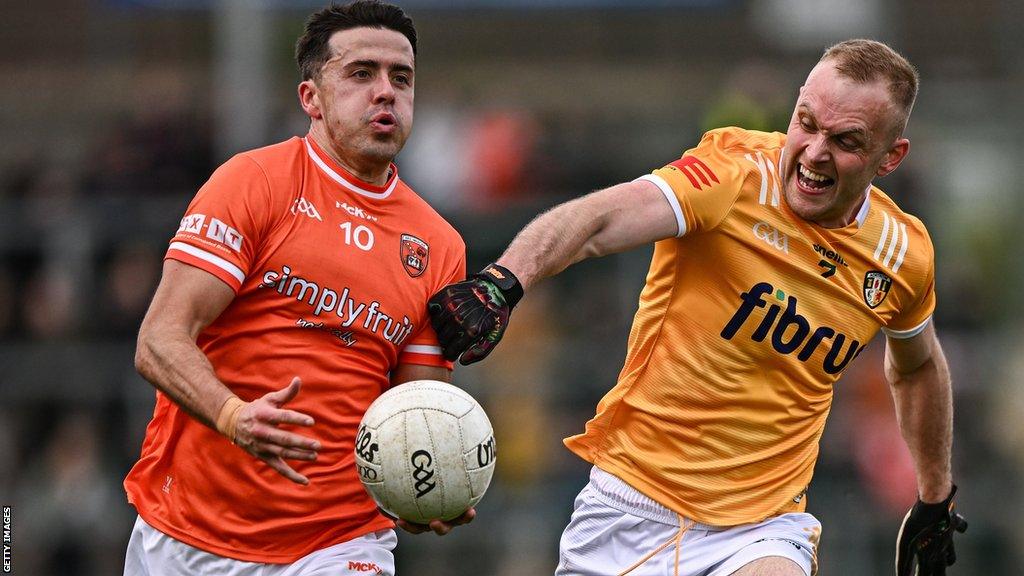 Antrim's Marc Jordan attempts to keep pace with Armagh's Stefan Campbell