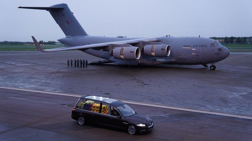 The Queen's coffin in a hearse, and the plane that flew it from Edinburgh to London.