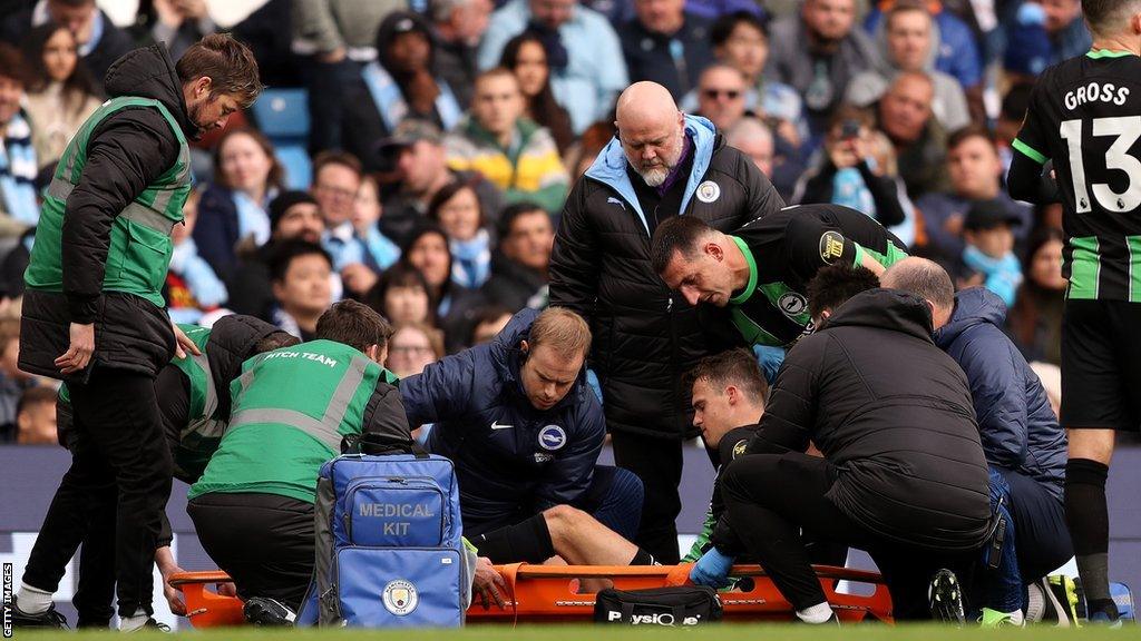 Solly March being taken off on a stretcher
