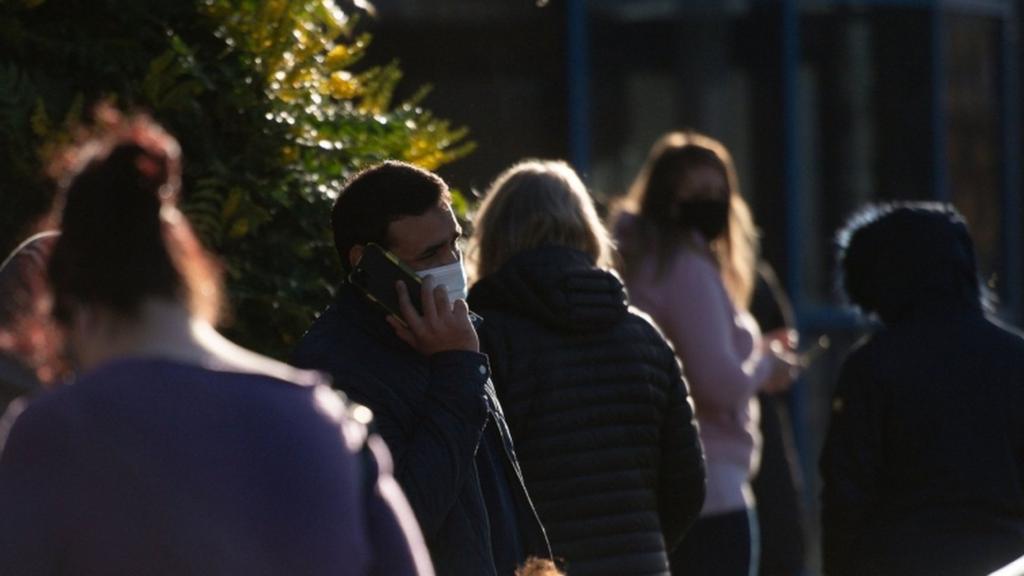 Man in a mask on the phone