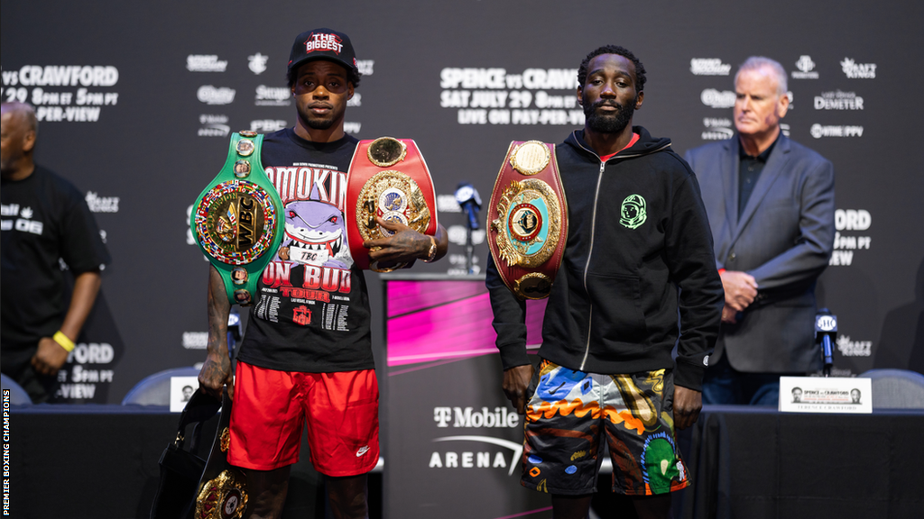 Errol Spence (L) and Terence Crawford pose for pictures with their world titles