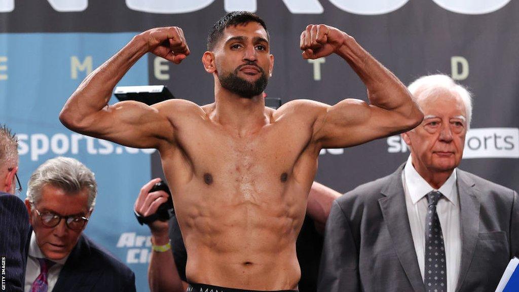 Amir Khan flexes on the scales