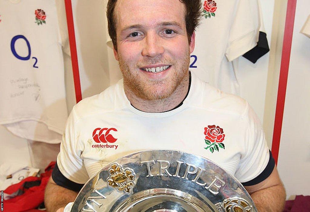 Henry Thomas holding Triple Crown trophy