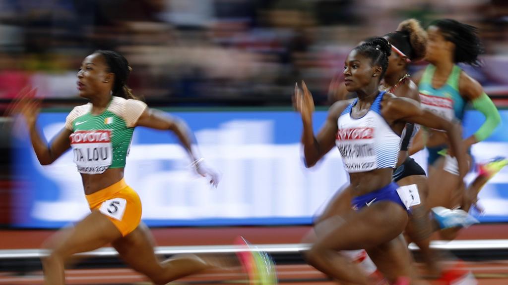 Women"s 200 Metres Semi-Final - London Stadium, London, Britain â€“ August 10, 2017. Marie-Josee Ta Lou of Ivory Coast wins the heat ahead of Dina Asher-Smith of Great Britain