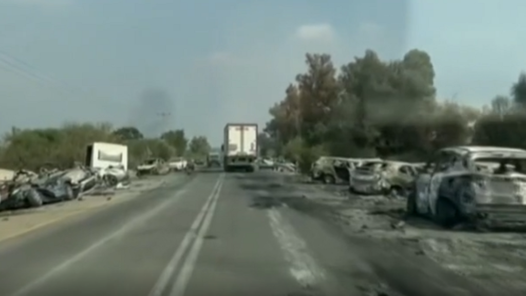 Destroyed cars line the roadside near the site of an attacked music festival in southern Israel