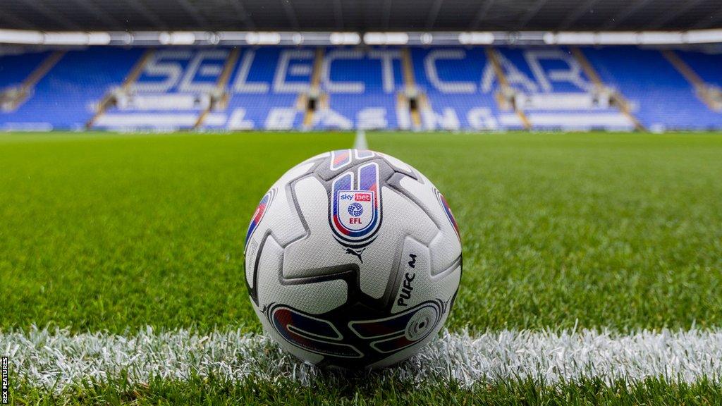 A low angle image of an official EFL football on the touchline at Reading FC's Select Car Leasing Stadium.