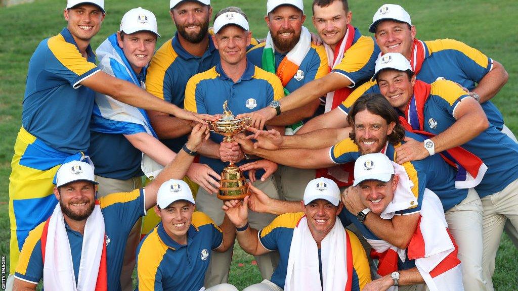 Europe's Ryder Cup team gathers round captain Luke Donald to all hold the trophy