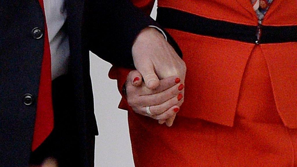 Trump and May holding hands