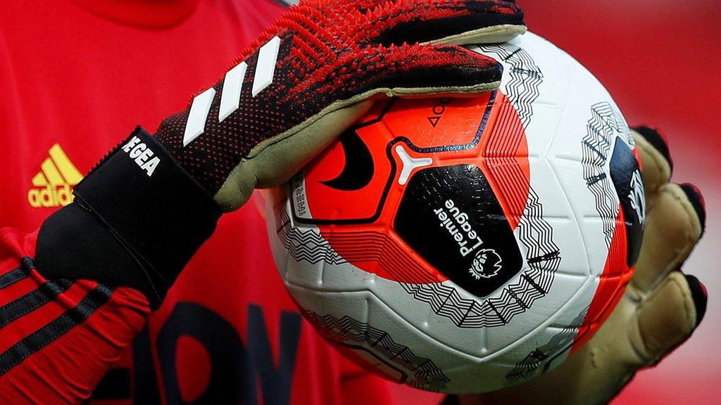 General view of a match ball held by Manchester United's David de Gea