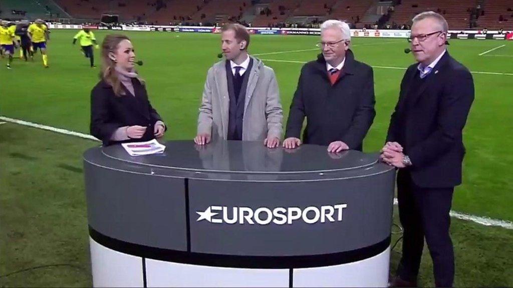 Four commentators stand around a table that reads 'Eurosport' as in the distance a group of Swedish players run to meet them.