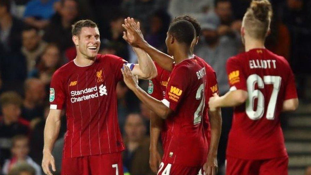 James Milner celebrates scoring for Liverpool against MK Dons