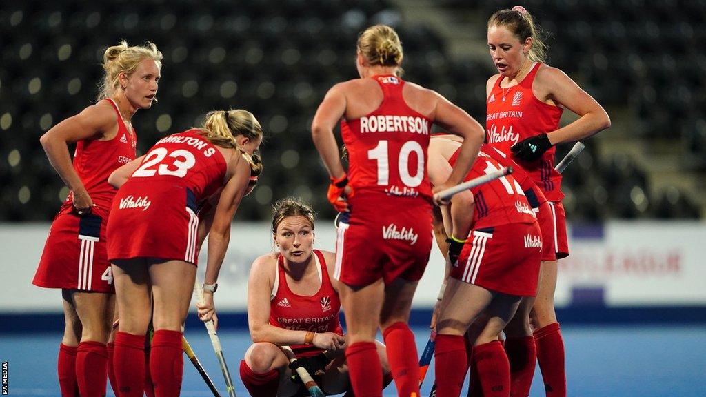 GB's women's team players in a huddle