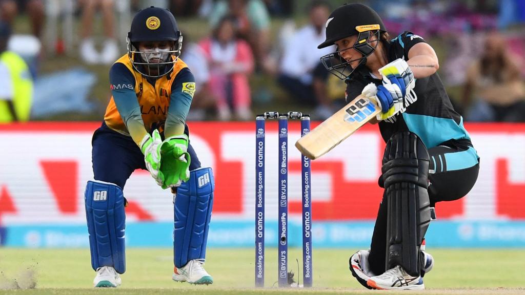 New Zealand's Bernardine Bezuidenhout (R) plays a shot as Sri Lanka's wicketkeeper Anushka Sanjeewani (L) looks on during the Group A T20 women's World Cup cricket match between New Zealand and Sri Lanka at Boland Park in Paarl