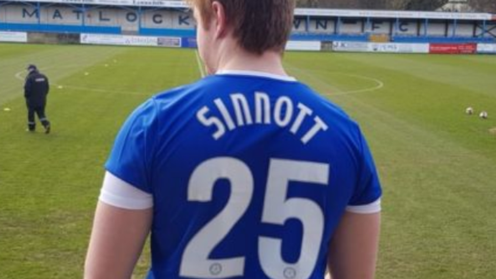 A Matlock Town fan wears a shirt with the name of Jordan Sinnott on the back