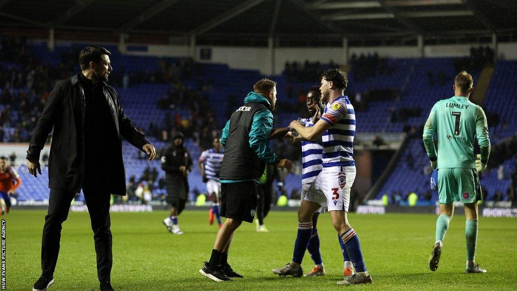 Swansea City manager Russell Martin has to be pushed away from Joe Lumley of Reading
