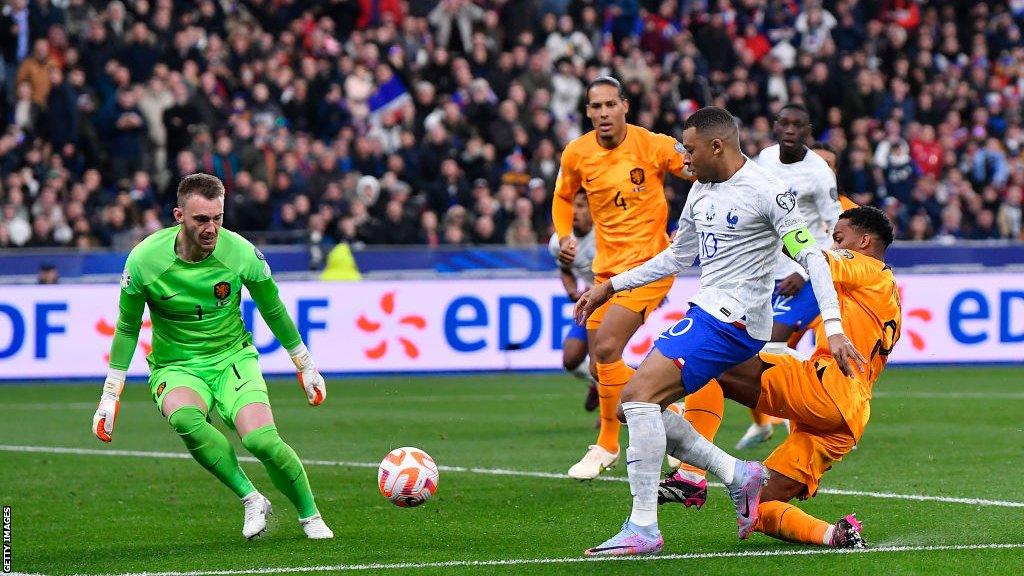 Kylian Mbappe takes a shot against the Netherlands