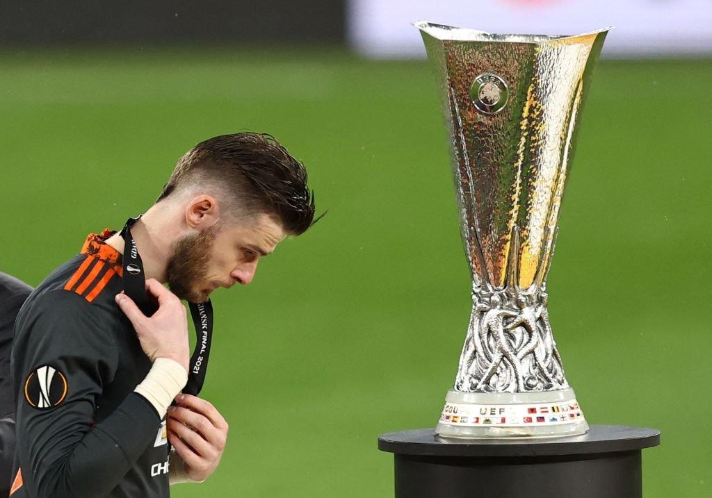 David DeGea walks past Europa League trophy.