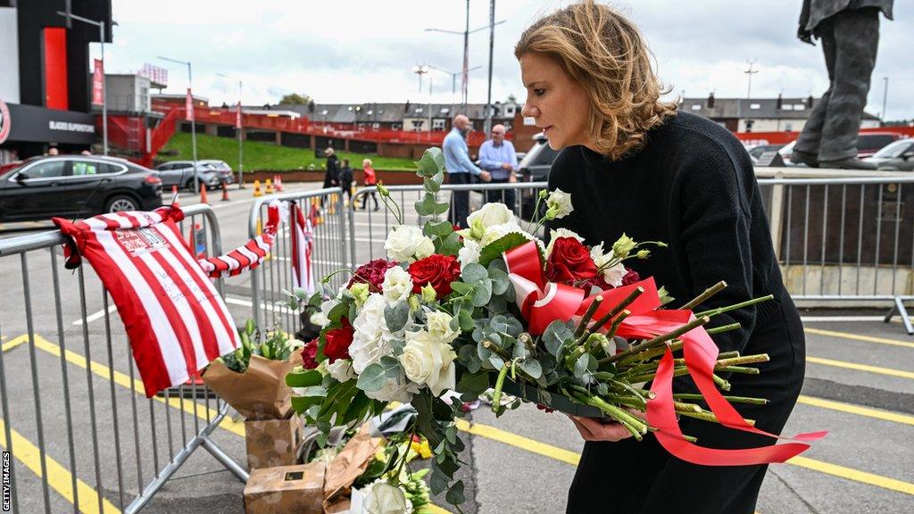 Amanda Staveley lays flowers