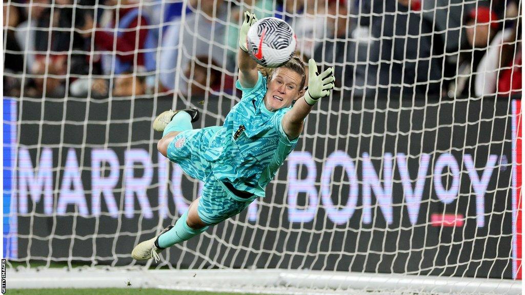 Alyssa Naeher saving a penalty in the shootout