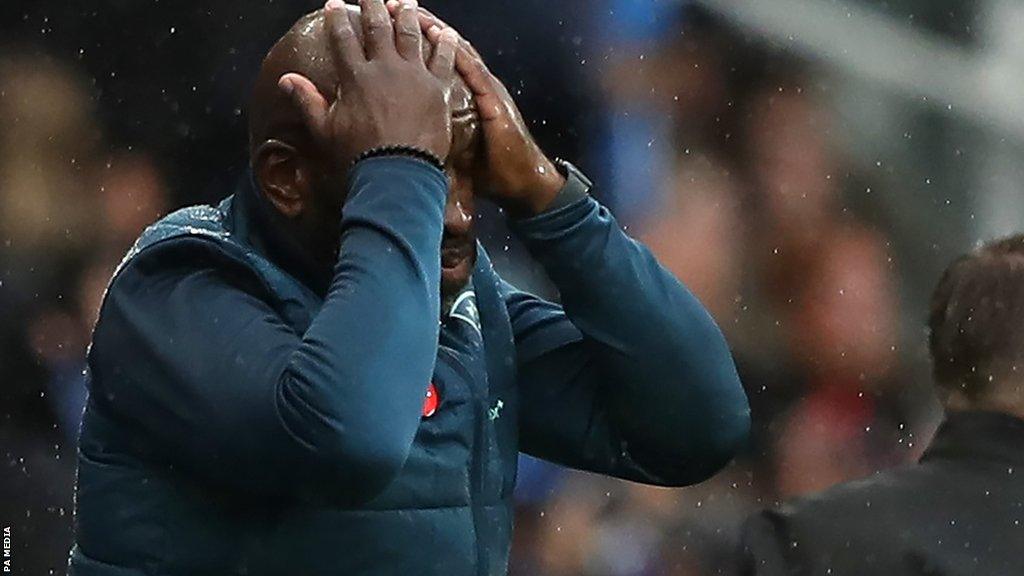 Darren Moore places his hands on his head after Ipswich draw with Huddersfield