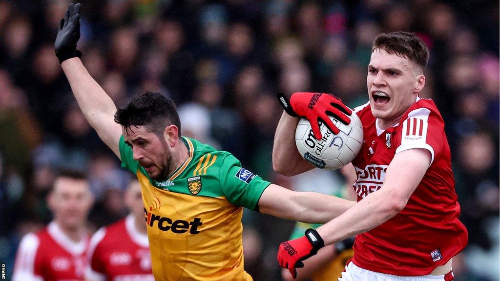 Ryan McHugh challenges Cork's David Buckley at MacCumhaill Park