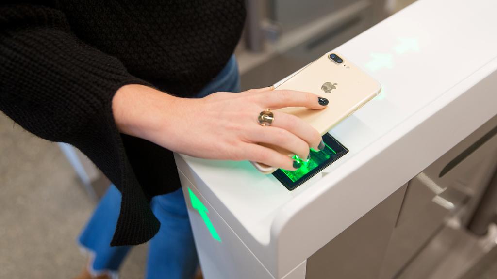 An Amazon employee scans in to shop at the Amazon Go store