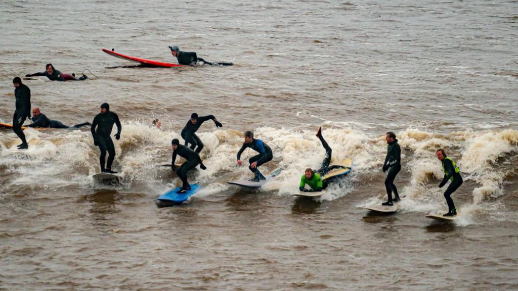 Surfers riding the river Severn bore