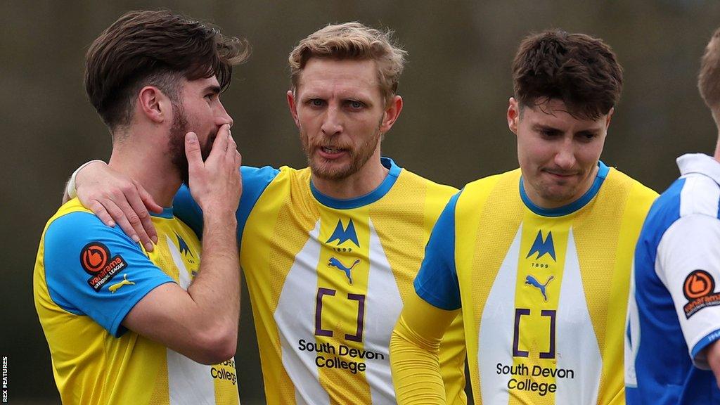 Dean Moxey speaks with a Torquay team-mate