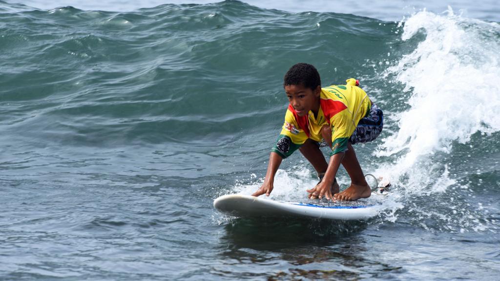 Boy surfing in Senegal