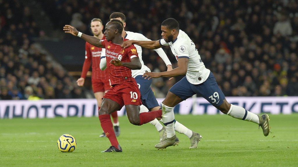 Sadio Mane (left) and Japhet Tanganga tussle for the ball